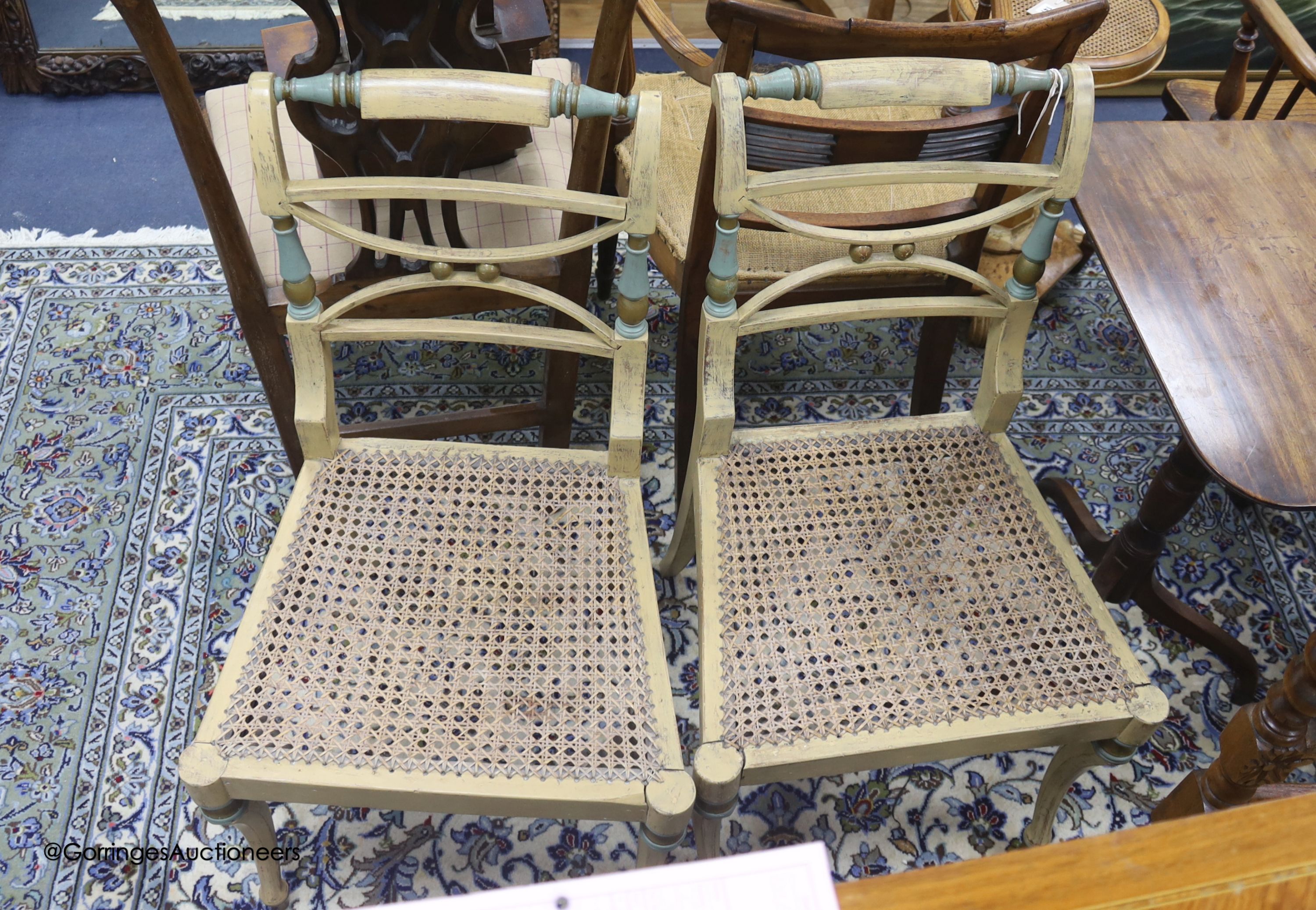 A pair of early 19th century part painted beech single chairs, with cane seats